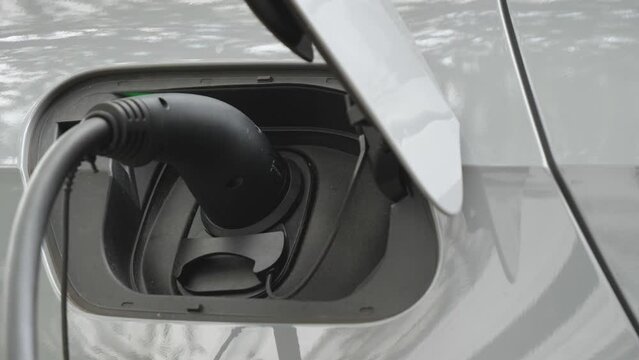 A close up view of an electric car being charged.