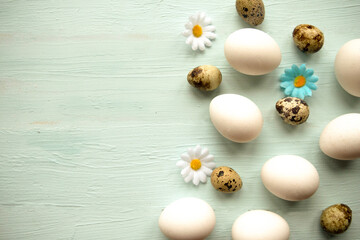 Quail and chicken eggs on wooden background. Easter concept. Copy space for the text