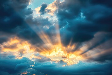 Sun beams breaking through dark clouds at sunset, symbolizing hope and grace.