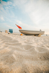 Boats on white sand on the sea coast .Sea transport. Sandy white dunes.Beach summer...
