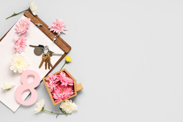 Composition with clipboard, keys and flowers on grey background. International Women's Day