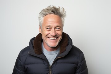 Portrait of a happy senior man laughing while wearing a warm jacket.