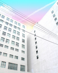 Low angle view of a white building with a pastel sunset