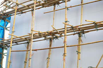 Bamboo scaffolding is installed around the building to support renovation or repaint.