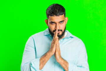 Sneaky cunning Indian young man with tricky face gesticulating and scheming evil plan, thinking...