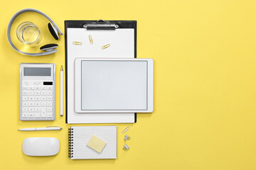 Flat lay composition with modern tablet on yellow background. Space for text