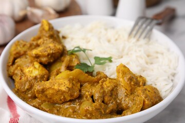 Delicious chicken curry with rice on table, closeup