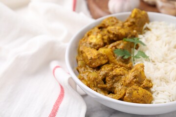 Delicious chicken curry with rice on table, closeup. Space for text