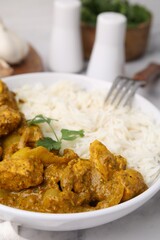 Delicious chicken curry with rice on table, closeup