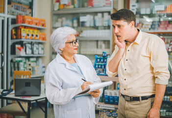 pharmacist is asking about a patient's condition in order to prescribe medication according to the patient's symptoms who come for prescription consultation in a modern pharmacy.