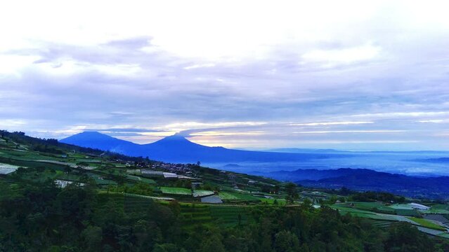 A lush green covered in Mount Sumbing slope of vegetables, taken from an aerial view.