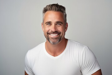 Portrait of a handsome smiling man in white t-shirt. - obrazy, fototapety, plakaty