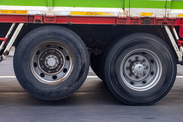 View of the rear wheels of a truck while driving with the rear axle raised - obrazy, fototapety, plakaty