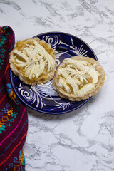 Flavorful Delight: Sopes with green sauce, cheese, and onion