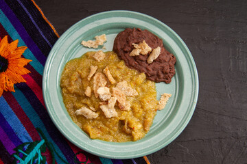 Mexican food; Chicharron with green sauce and refried beans