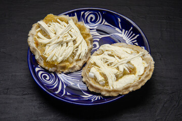 Flavorful Delight: Sopes with green sauce, cheese, and onion