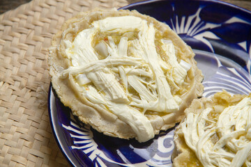 Flavorful Delight: Sopes with green sauce, cheese, and onion
