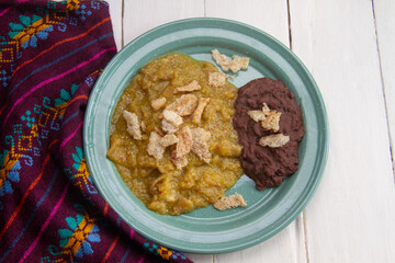 Mexican food; Chicharron with green sauce and refried beans