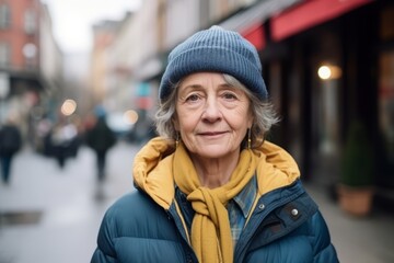 Portrait of an elderly woman in a hat on a city street