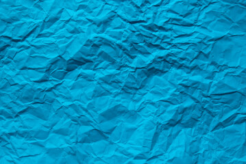 Blue color crumpled paper for background.