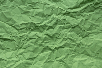 Green color crumpled paper for background.