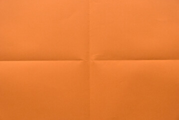 Folded orange color paper for background.