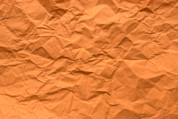 Orange color crumpled paper for background.