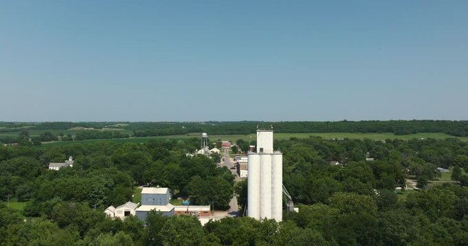 Fly past large silo tower structure over town midwest kansas