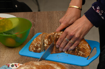 woman cutting freshly baked homemade bread in the kitchen 4