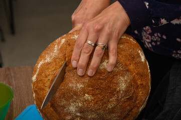 woman cutting a loaf of freshly baked homemade bread 6