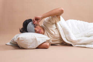 Happy man in sleeping eye mask ready to sleep. People, bedtime and rest concept