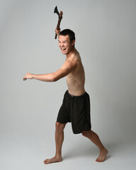 Full length portrait of fit handsome shirtless asian male model,  Holding viking axe weapon,...