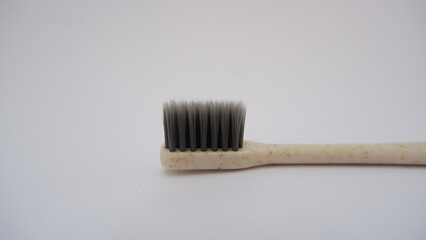 Close up toothbrush on white background. Gray toothbrush bristles. Selective focus. Teeth care concept.