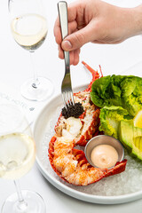 Half lobster served with black caviar and salad. 