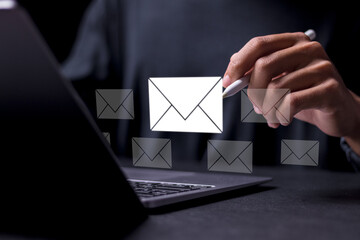 Email marketing concept. Person using laptop to sending many e-mails or digital newsletter to...