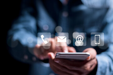 Contact us concept. Person using smartphone with virtual contact us icon or Customer support hotline people connect.