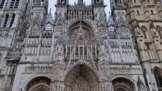 Outdoor facade view of Notre Dame de Rouen Cathedral in the Normandy, France. Architectural landmark featuring styles from Early Gothic to late Flamboyant and Renaissance architecture