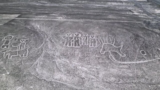 Aerial panorama view of mysterious humnoid creatures  in the Peruvian desert in Nazca.