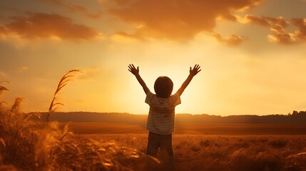 A little boy raises his hands above the sunset sky, enjoying life and nature. Happy kid on a summer field looking at the sun. Silhouette of a male child in the sun. Fresh air, environment concept. - obrazy, fototapety, plakaty