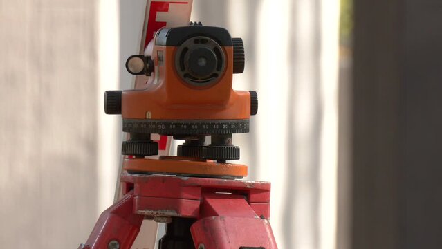 Engineering and geodesic equipment for accurate level measurements before carrying out large construction projects. Surveyor equipment tacheometer or theodolite outdoors at construction site
