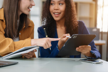 Business colleague business presents and explains and using laptop and tablet. Teamwork, financial marketing team