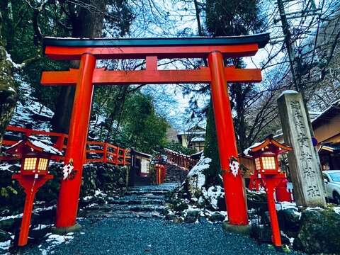 The snow-covered torill (shrine gate) and red lantern box at Kifune Shrine at Kyoto, Japan at winter night 