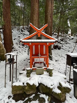 The little shrine on the hiking trail in the snowy forest to the Kuramadera Temple at Kyoto, Japan on a winter day