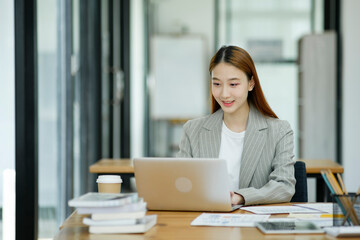 Woman sitting at work on a casual day with coffee.
