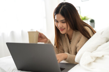 Fototapeta premium Young smiling asian woman happy relax use laptop conference work,learning, education, shopping, study online, webinar, online marketing, business, blog, digital internet advertising at home
