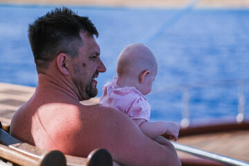 Father and daughter in the sea on boat or yacht. Family, adventure and skipper concept