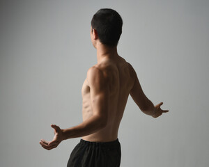 Close up portrait of fit asian male model, shirtless with muscles.  gestural ti chi inspired posing...