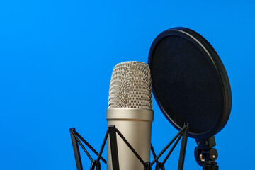 Professional microphone stand over blue studio background
