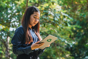 Business Woman using tablet to analyze  ESG concept ,Sustainable development goal (SDGs) Ideas Globe Glass  energy-based green business can limit climate change and global warming.