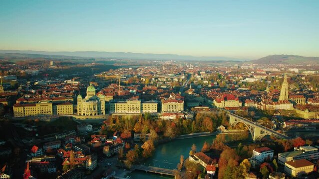 Evening View Of The Swiss Parliament Building By The River Aare During Autumn, Old City Of Bern In Switzerland. Helicopter Aerial